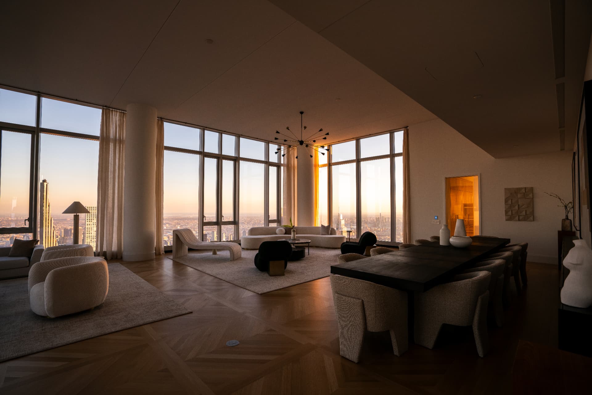 Open-plan penthouse with dining table at dusk